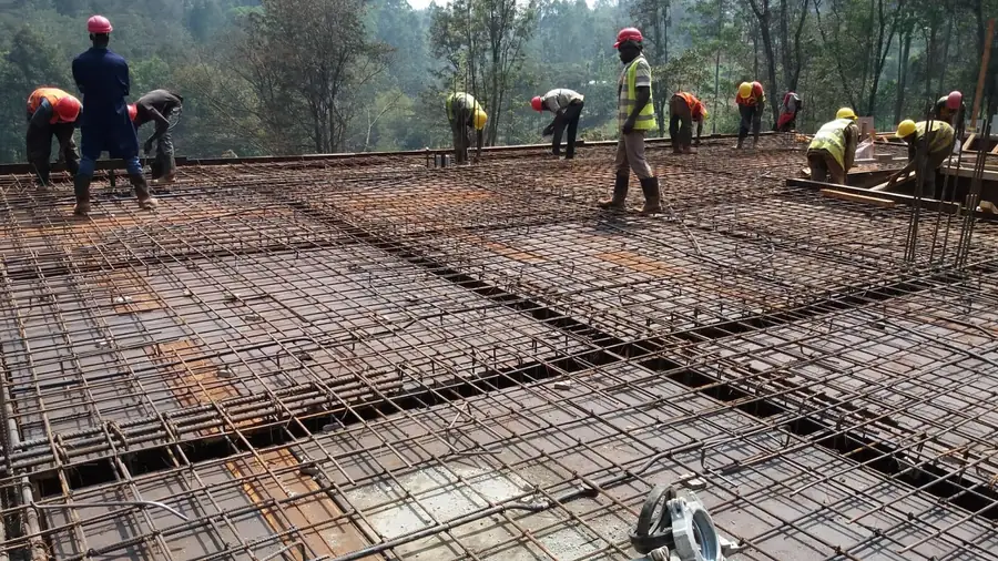 Steel fixers tying a large slab reinforcement mesh